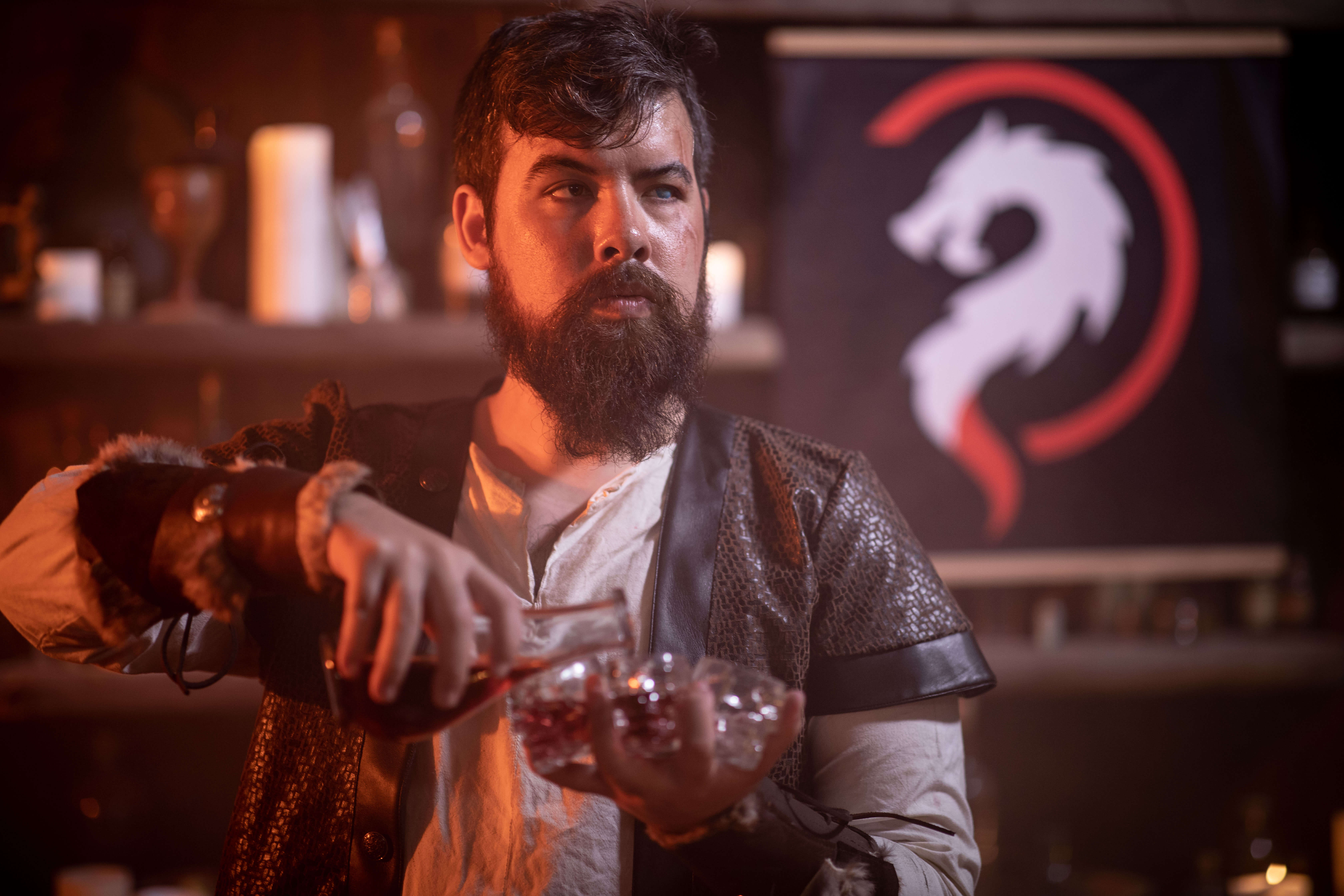 A human dungeons and dragons character pours a potion.